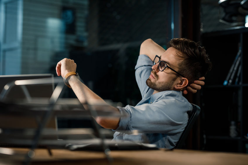 man working his in office checking time