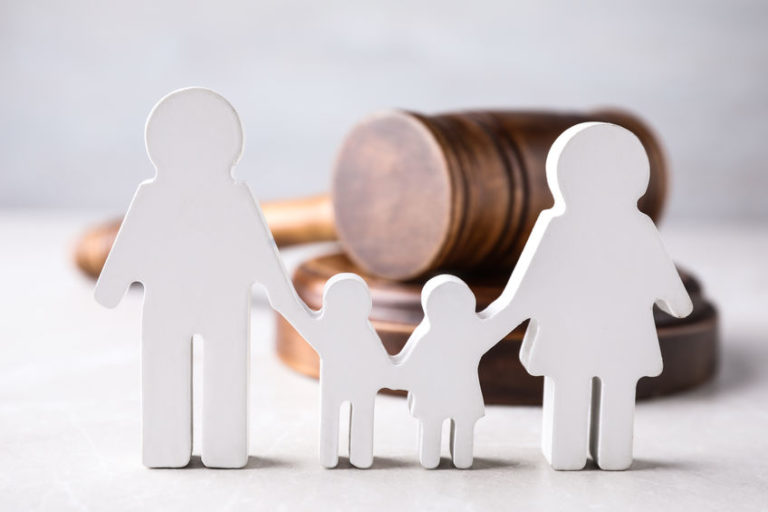 White figures of family on light colored table with wooden gravel