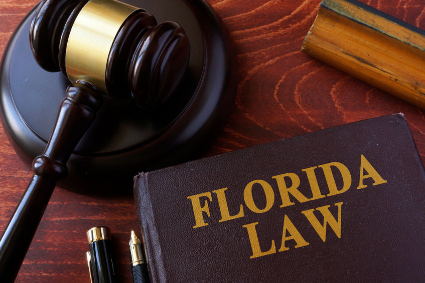 Florida Law book and gravel on desk in reference to Florida Game Promotion Law