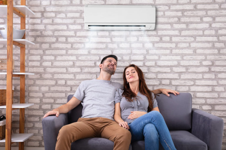 Couple Sitting On Couch Under Air Conditioner in reference to tenant rights