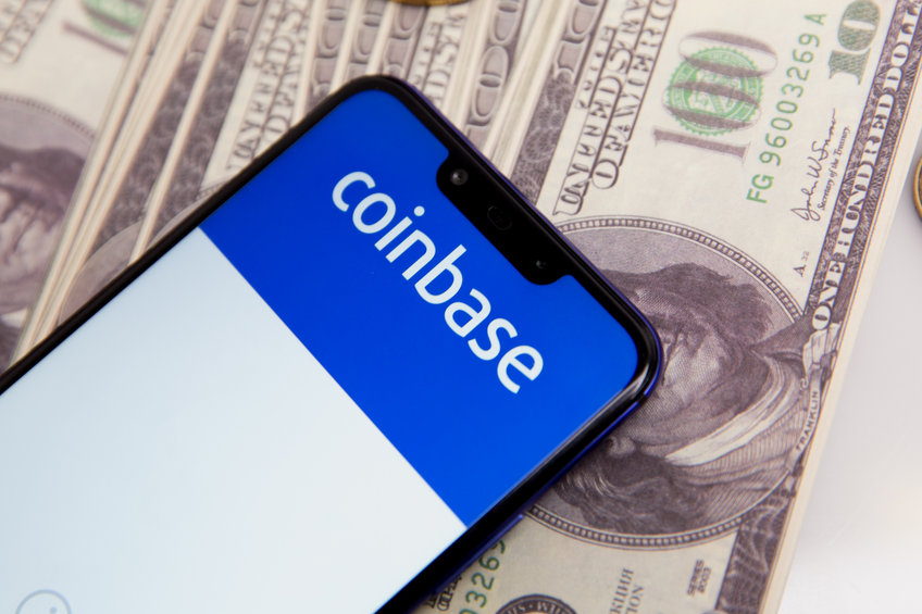 Image of phone with coinbase screen with money in background