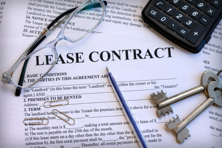 Picture of Lease Contract with glasses, keys, and calculator on table