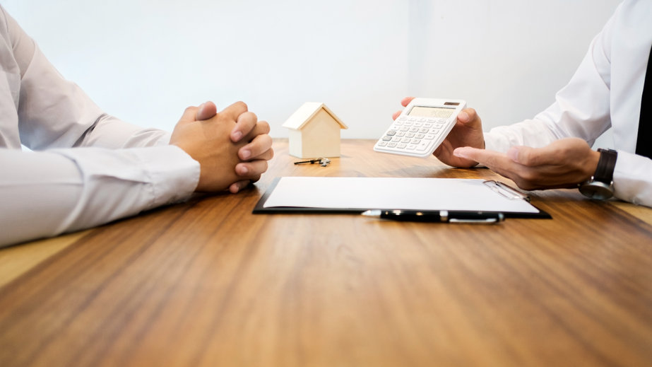 Real Estate agent showing a contract signature with customer