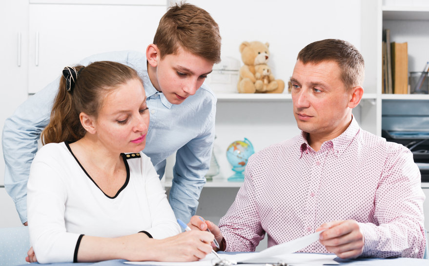 Mother and son signing contract