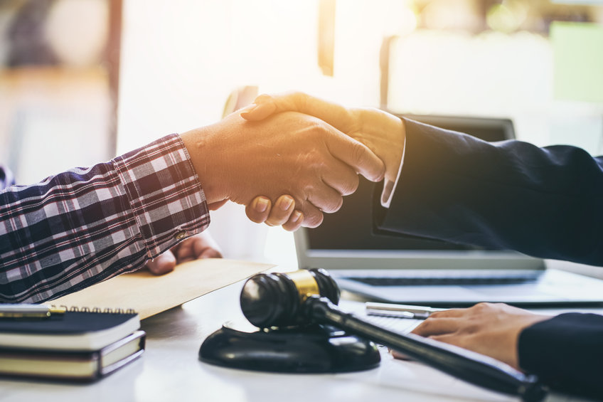 Lawyer and a client shake hands after agreeing