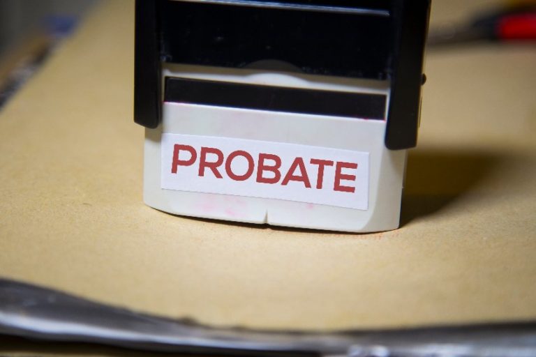 The word probate on a stamp on a big folder of paperwork