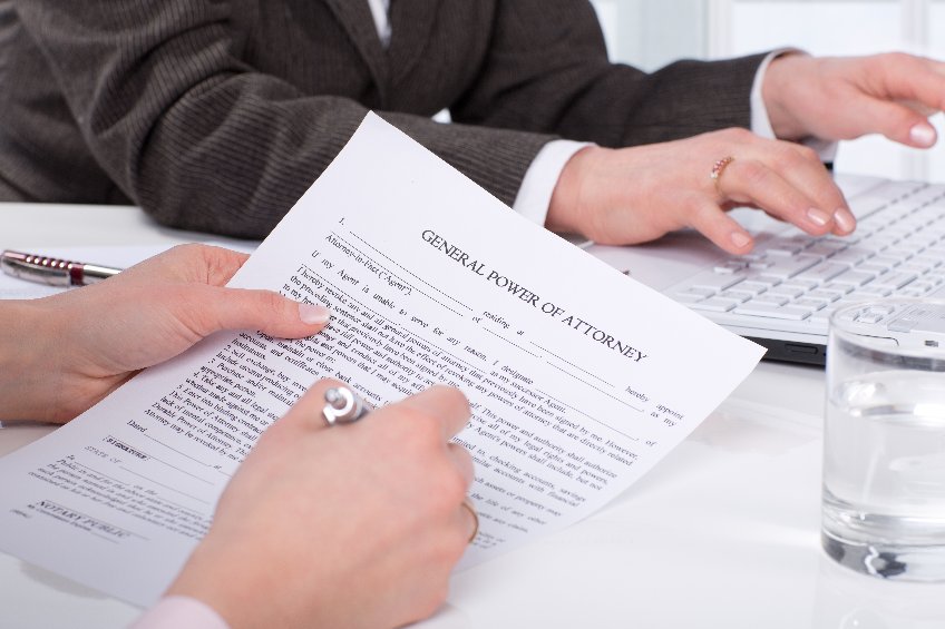 Hands of the woman signature document sitting on desk