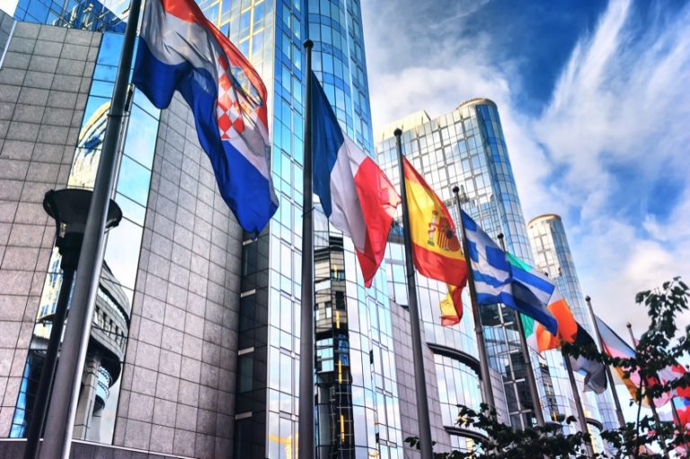 Picture of waiving flags in front of commercial building