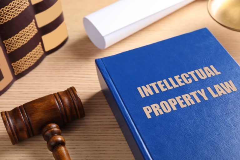 Picture of Intellectual Property law book and judge's gavel on wooden table