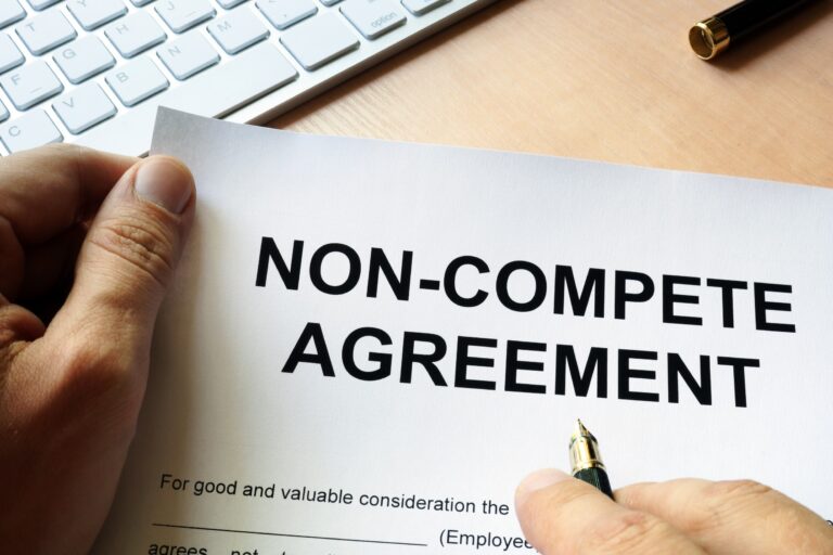 Picture of a man signing a Non compete agreement
