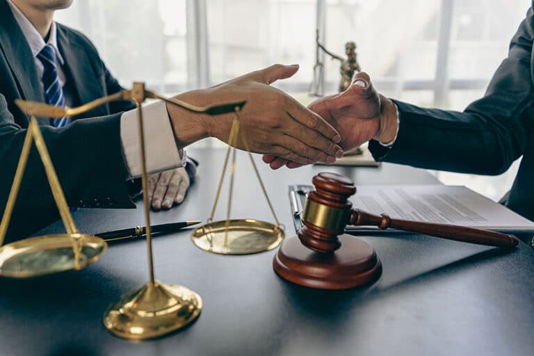Two individuals are in the process of settling a dispute, weighing the options of arbitration against litigation.