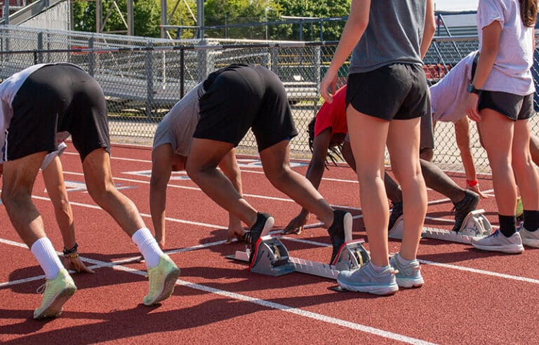 Athletes in run track representing NIL