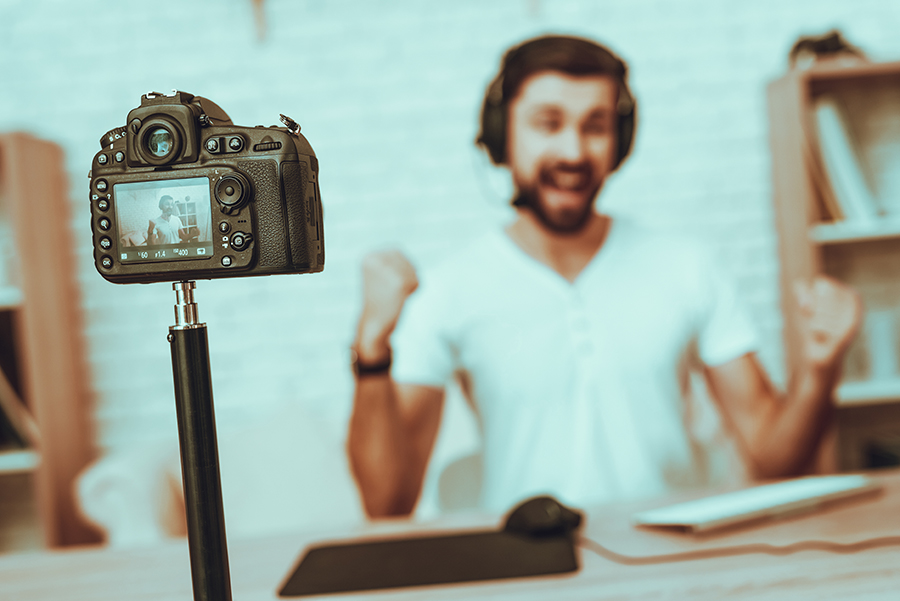 An image of camera filming a streamer while playing some game