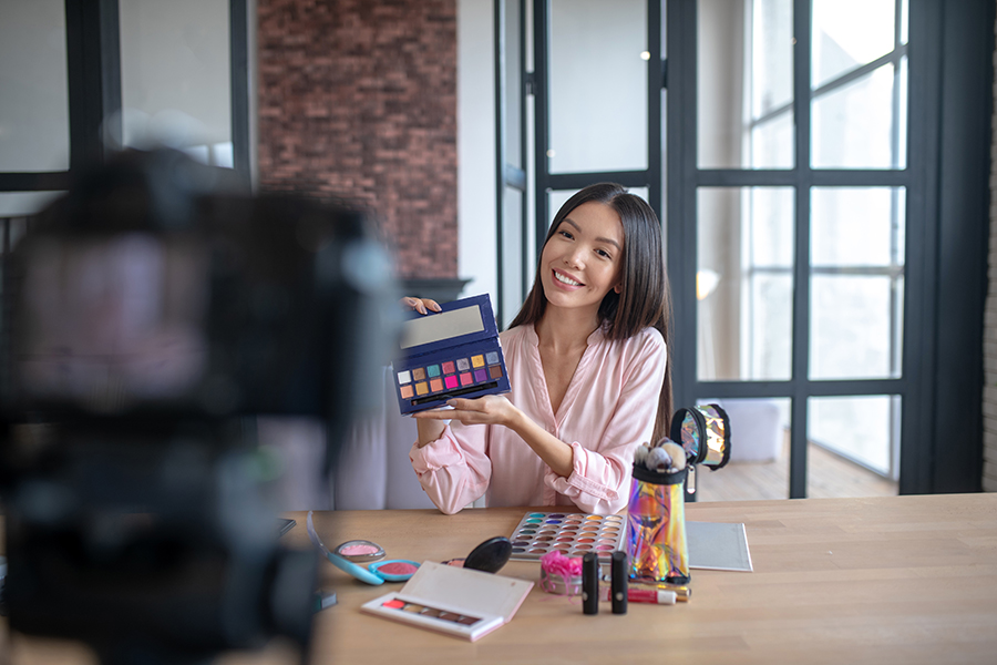 Woman content creator filming some beauty make up video